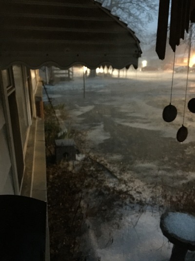 This is the front yard alongside the house. There's an icy flow of water heading away from me in this picture and coalescing in a run-off towards our backyard and the aforementioned lake. Noteworthy is you can see where the eaves of the house are by the long line of clear terrain.